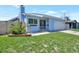 Charming one story home featuring manicured lawn, classic siding, and an attached garage at 1451 S Quitman St, Denver, CO 80219