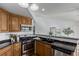 Kitchen featuring dark countertops, stainless steel appliances, and a decorative shelf detail at 1451 S Quitman St, Denver, CO 80219