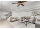 Basement living room with neutral decor, modern furniture, and a staircase in view at 1451 S Quitman St, Denver, CO 80219