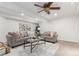 Bright basement living room featuring neutral-toned sofas, glass table, and decorative wall art at 1451 S Quitman St, Denver, CO 80219