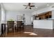 Open living space flows from the kitchen to dining area with hardwood floors and lots of light at 1451 S Quitman St, Denver, CO 80219