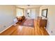Bedroom featuring hardwood floors, bright window with lace curtains, vintage furniture decor, and en-suite access at 4060 Shaw Blvd, Westminster, CO 80031