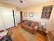 Cozy bedroom space featuring a comfortable couch, hardwood floors, and ample storage in the closet at 4060 Shaw Blvd, Westminster, CO 80031