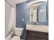 Bathroom featuring a single sink vanity with dark wood cabinets and a framed mirror at 1008 N Corona St # 403, Denver, CO 80218
