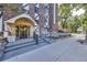 Welcoming entrance to a brick condominium building with landscaped surroundings at 1008 N Corona St # 403, Denver, CO 80218