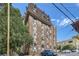 Apartment building features brick exterior, geometric trim, and multi-paned windows at 1008 N Corona St # 403, Denver, CO 80218