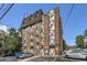 Apartment building features brick exterior, geometric trim, and multi-paned windows at 1008 N Corona St # 403, Denver, CO 80218