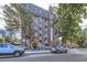 Brick condominium building with well-maintained landscaping and street parking at 1008 N Corona St # 403, Denver, CO 80218