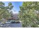 A brick building with a beautiful lawn, set back from the street and shaded by mature trees at 1008 N Corona St # 403, Denver, CO 80218