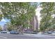 Brick condominium building with well-maintained landscaping and street parking at 1008 N Corona St # 403, Denver, CO 80218