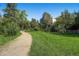 Expansive green space with walking path and mature trees surrounding the property at 1008 N Corona St # 403, Denver, CO 80218