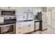 Kitchen with stainless steel appliances, white cabinets, and subway tile backsplash at 1008 N Corona St # 403, Denver, CO 80218