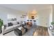 Bright living room featuring contemporary decor, hardwood floors, and an opening to the kitchen at 1008 N Corona St # 403, Denver, CO 80218