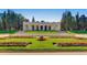 Marble building with columns surrounded by green grass and flowers at 1008 N Corona St # 403, Denver, CO 80218