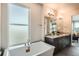Spa-like bathroom with a modern soaking tub, double vanity, and stylish lighting for a serene atmosphere at 1764 Peak Loop, Broomfield, CO 80023
