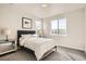 Bright bedroom with a queen size bed, two windows, and modern accents at 1764 Peak Loop, Broomfield, CO 80023