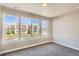 Sunlit bedroom with three large windows showcasing the community exterior at 1764 Peak Loop, Broomfield, CO 80023