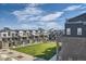 Beautiful community featuring lush green space and modern townhome exteriors at 1764 Peak Loop, Broomfield, CO 80023