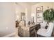 Chic office space with wooden desk, potted plant, and artwork, offering a bright and organized workspace at 1764 Peak Loop, Broomfield, CO 80023