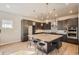 This gourmet kitchen has a large island, sleek cabinetry, and modern appliances at 1764 Peak Loop, Broomfield, CO 80023