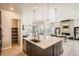 Open-concept kitchen with a large island and stainless steel appliances at 1764 Peak Loop, Broomfield, CO 80023