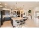 This modern kitchen features an island with stool seating and views of the adjacent living space at 1764 Peak Loop, Broomfield, CO 80023