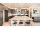 This modern kitchen features an island with stool seating and plenty of cabinet storage at 1764 Peak Loop, Broomfield, CO 80023