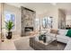 Bright living room with fireplace, light wood floors and large windows at 1764 Peak Loop, Broomfield, CO 80023