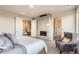 Inviting main bedroom with a fireplace, sitting area, and ensuite bathroom access, designed for relaxation at 1764 Peak Loop, Broomfield, CO 80023