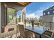 Inviting patio with dining table and chairs, perfect for outdoor meals and relaxation against a backdrop of community views at 1764 Peak Loop, Broomfield, CO 80023