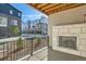 Outdoor patio area with a stone fireplace and community views at 1764 Peak Loop, Broomfield, CO 80023