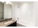 Bathroom features a shower over tub, and a vanity with granite counters at 6654 Pecos St, Denver, CO 80221
