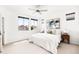 Bright bedroom featuring neutral decor, carpet, and large windows with neighborhood views at 6654 Pecos St, Denver, CO 80221