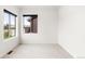 Bright bedroom features two windows, neutral carpet, and white walls, offering a serene and comfortable space at 6654 Pecos St, Denver, CO 80221