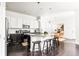 Modern kitchen with white cabinets, dark countertops, and stainless steel appliances at 6654 Pecos St, Denver, CO 80221