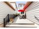 Side patio with table and chairs, bordered by landscaping, offers privacy and outdoor enjoyment at 6654 Pecos St, Denver, CO 80221