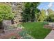 Beautiful backyard with lush lawn, garden beds, flower bed, and storage shed at 3190 S Detroit St, Denver, CO 80210
