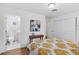 Bright bedroom features closet, en-suite bathroom, wood floors, and stylish decor at 3190 S Detroit St, Denver, CO 80210