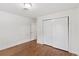 Bedroom with hardwood floors, double-door closet, white walls, and recessed lighting at 3190 S Detroit St, Denver, CO 80210