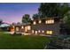 Evening exterior of brick home highlighting the backyard and landscaping at 3190 S Detroit St, Denver, CO 80210