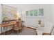 Cozy home office featuring hardwood floors, a wooden desk, a cozy chair, and ample natural light at 3190 S Detroit St, Denver, CO 80210