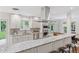 Bright kitchen with granite countertops, stainless steel appliances, white cabinetry, and a view to the backyard at 3190 S Detroit St, Denver, CO 80210