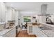 Modern kitchen features granite countertops, stainless steel appliances, and a view into the dining area at 3190 S Detroit St, Denver, CO 80210