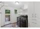 Convenient laundry room equipped with modern washer and dryer, with tile floors and outdoor access at 3190 S Detroit St, Denver, CO 80210