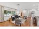 Spacious living room with hardwood floors, neutral decor, and a view to the stairs at 3190 S Detroit St, Denver, CO 80210