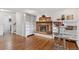 Cozy living room with brick fireplace, hardwood floors, built-in bookshelves, and stylish bar stools, creating a charming ambiance at 3190 S Detroit St, Denver, CO 80210
