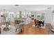 Bright open-concept living space with hardwood floors, modern decor, and dining area at 3190 S Detroit St, Denver, CO 80210