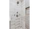 Modern shower featuring marble-style tiling, a rainfall shower head, and a built-in niche at 3190 S Detroit St, Denver, CO 80210