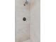 Beautiful shower with light stone-like tiles, updated shower head and faucet for a spa-like experience at 3190 S Detroit St, Denver, CO 80210