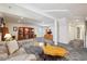 Spacious basement with display cases, built-in desk, bright lighting, and comfortable seating at 22560 E Rowland Dr, Aurora, CO 80016